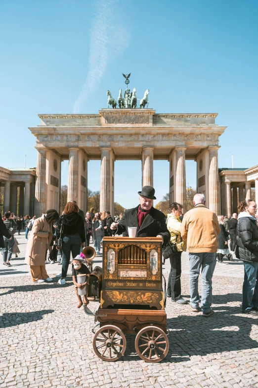 an antique stereo car with people standing outside