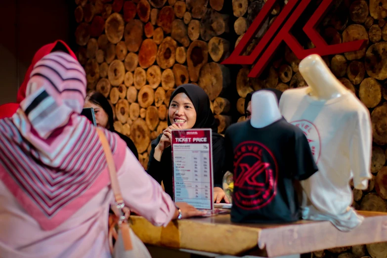 a woman stands next to a table with a menu