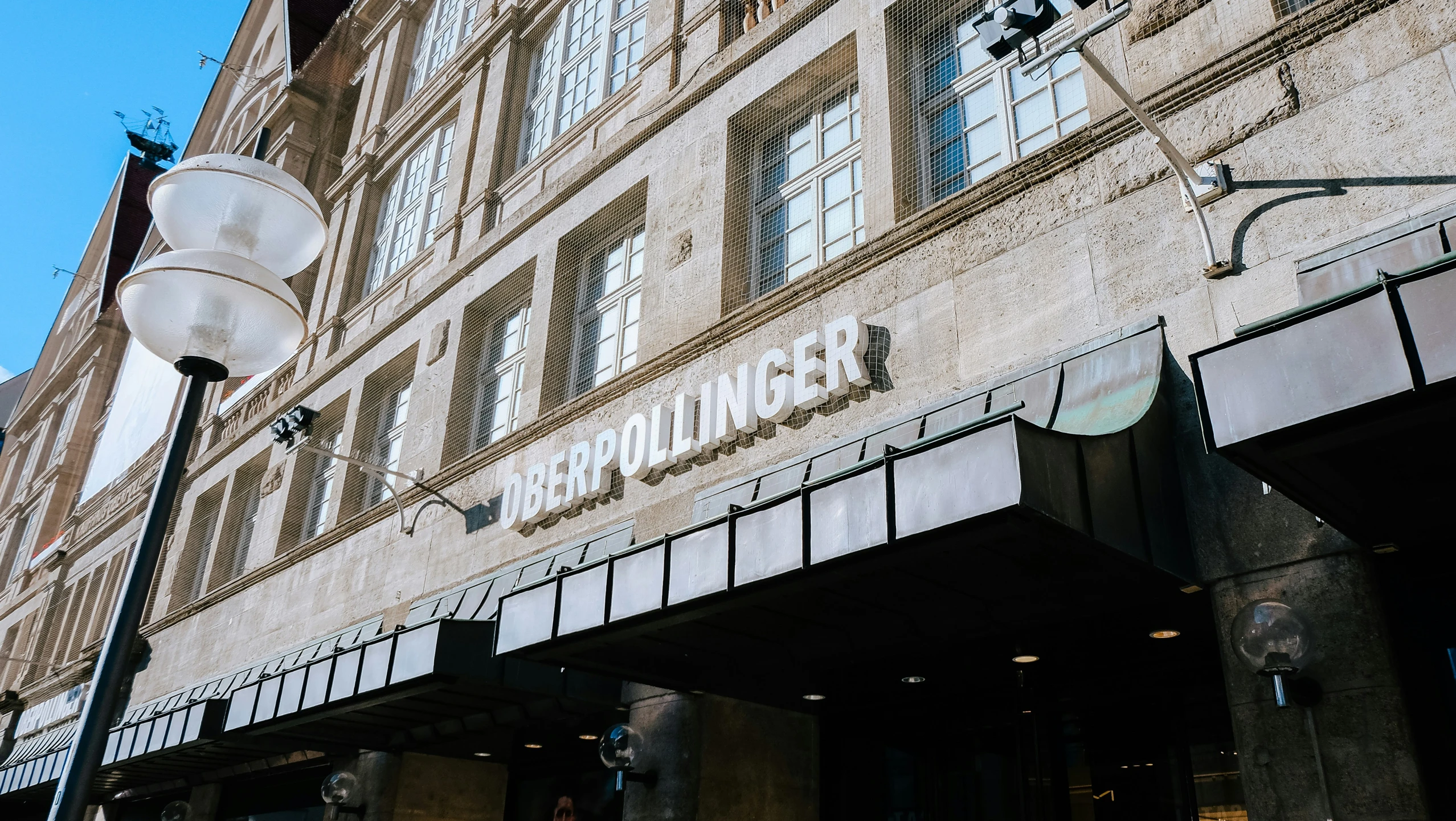 a building has windows and iron bars above the sign