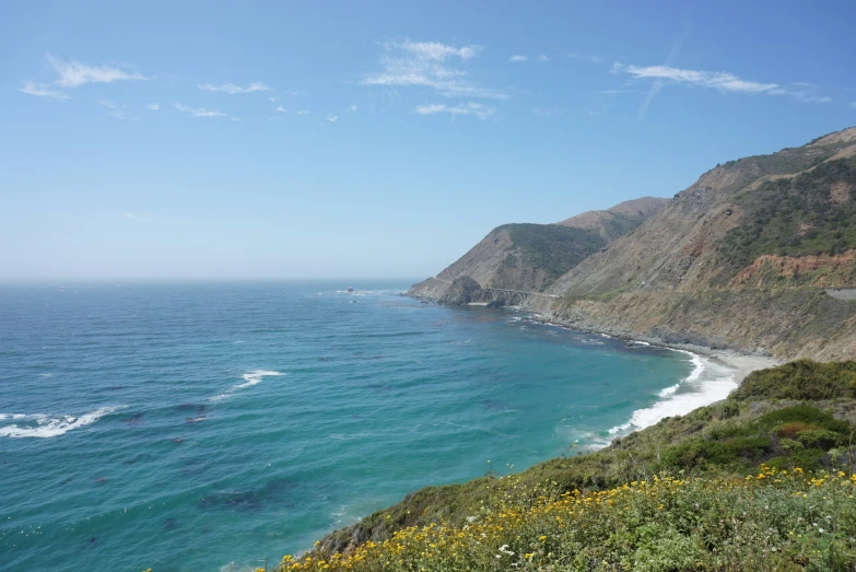 cliffs on the side of an ocean next to a cliff