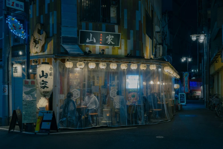 a shop on the side of the street at night