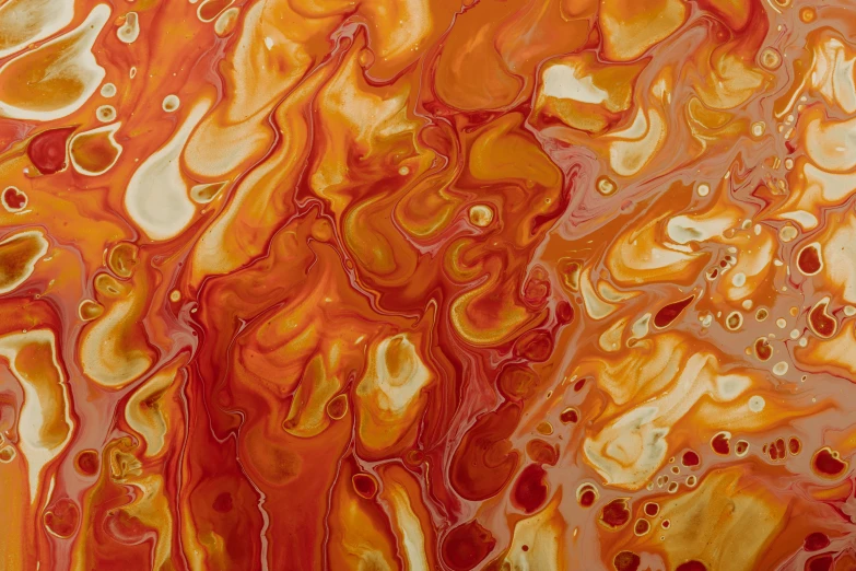an image of yellow and red liquid pouring from a tube