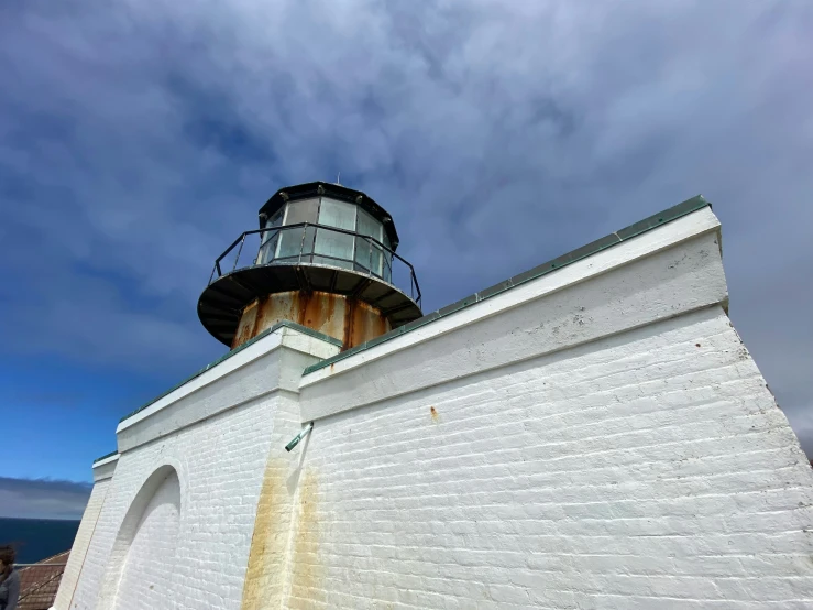 a white brick lighthouse on top of a building