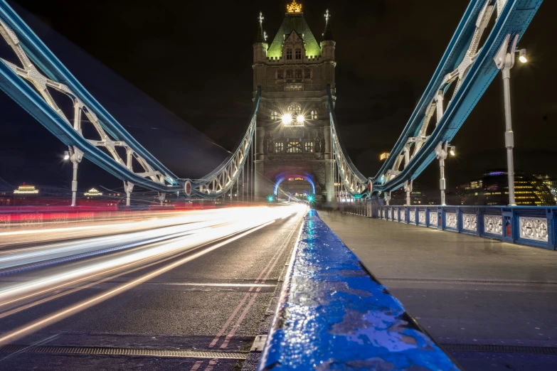 a large bridge over a street with traffic lights on it