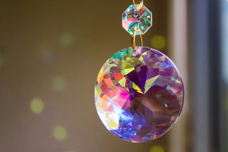 a colorful diamond hanging from a clear ornament