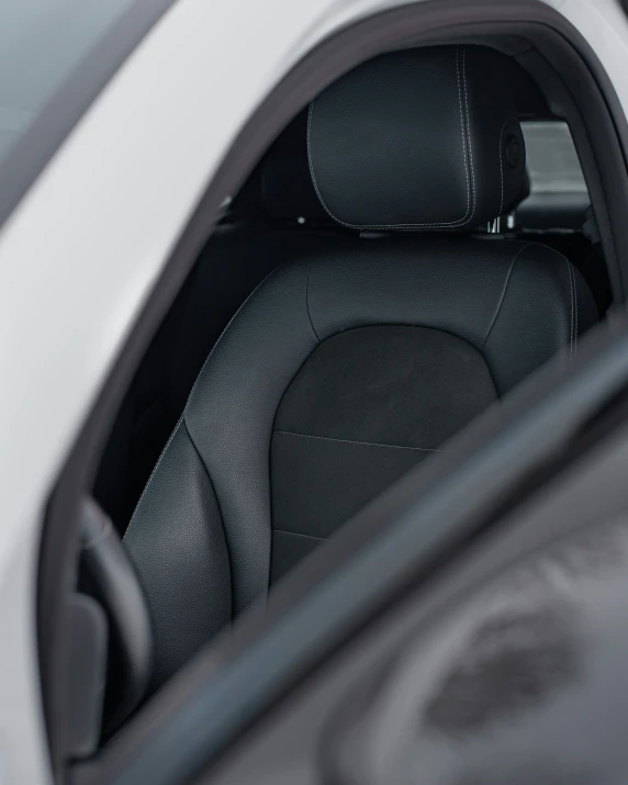 view from the back seat of a car with a clock in the front