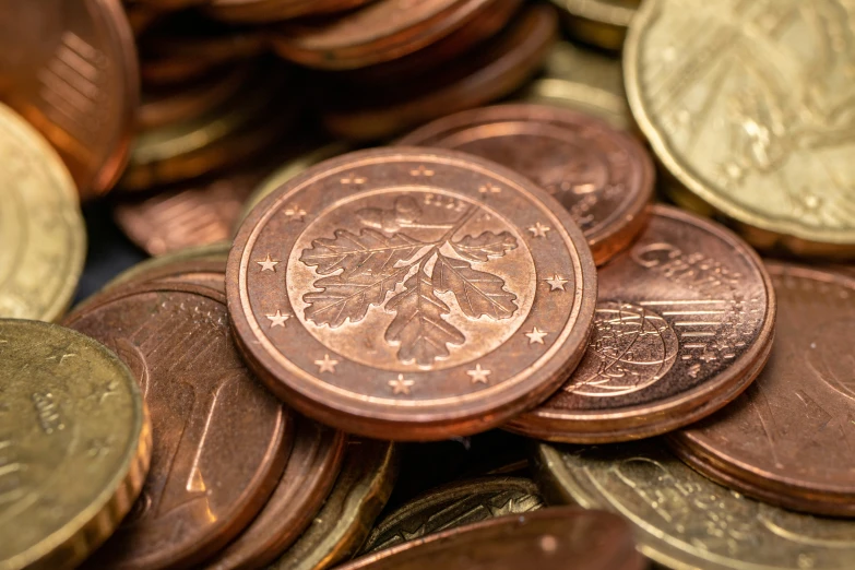 a pile of different colored canadian coins