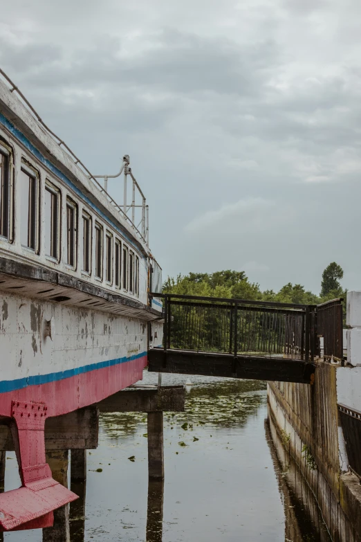 the boat is parked on a wooden dock with other items around