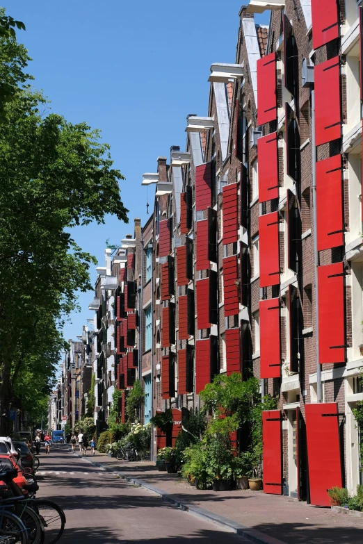 this po depicts an urban street lined with red brick buildings and lots of motorcycles