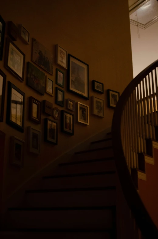 a stair case with pictures on the wall