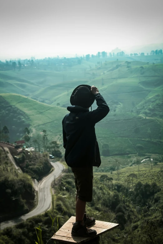 the man is looking out over the countryside