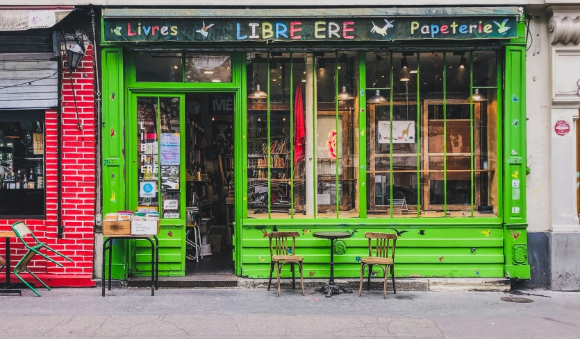 the storefront of a business has green and red colors