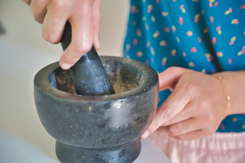 a close up of someone using a metal spoon