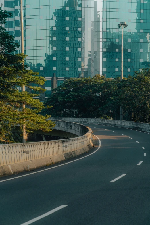 street with a curve in the road with skyscrs in the background