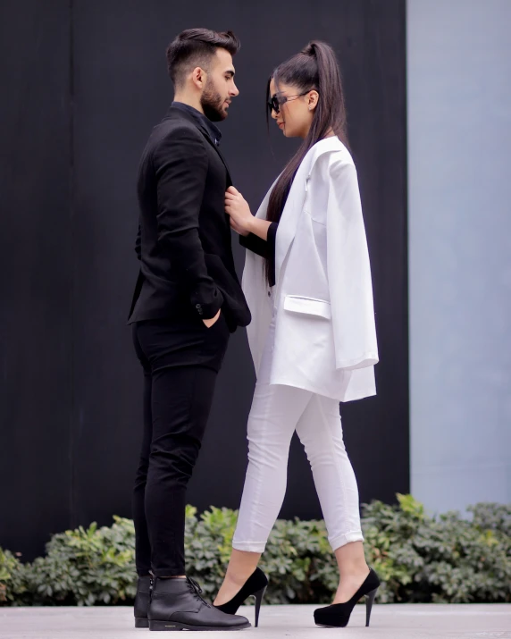 a man and woman standing close together on the street