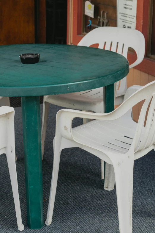 a closeup view of the dining table and chairs that appear to be used