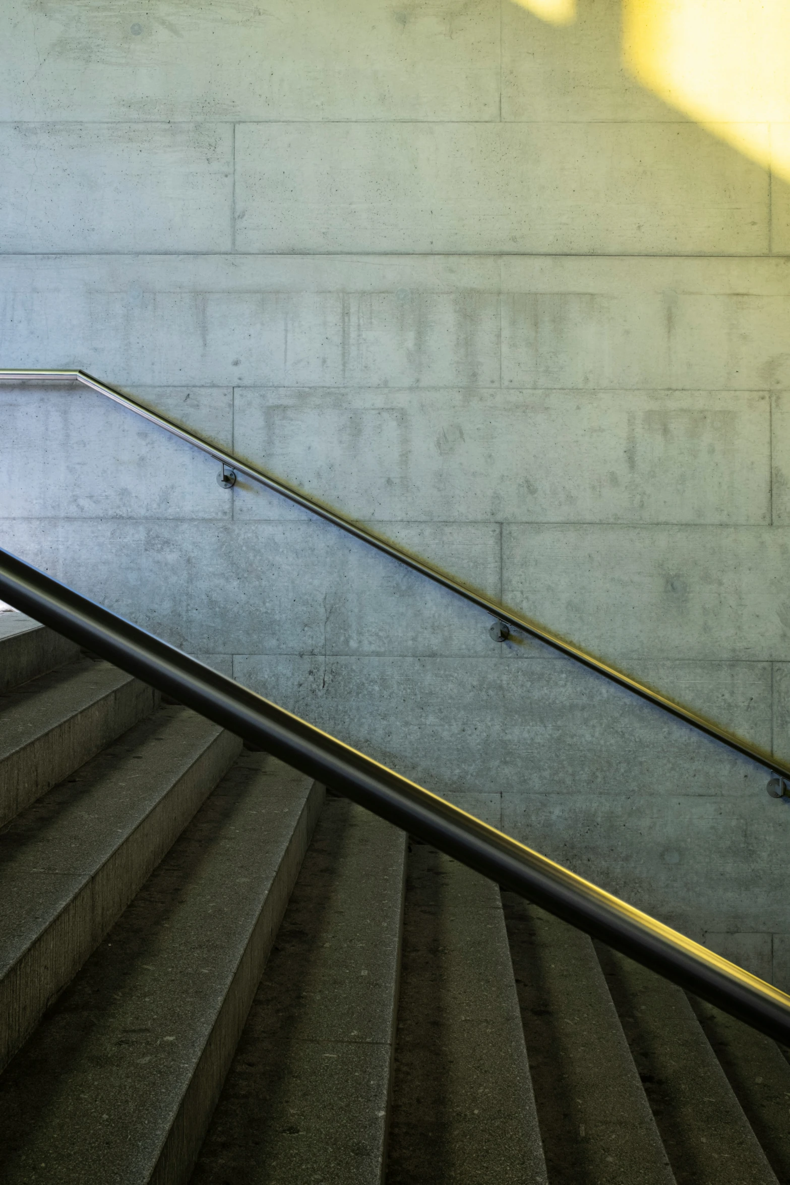 the sun is shining down on a person walking up some stairs