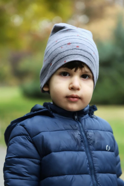 a small child stands in a grassy area