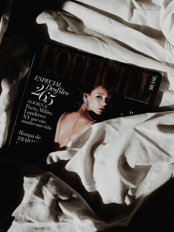 a magazine laying on top of a bed