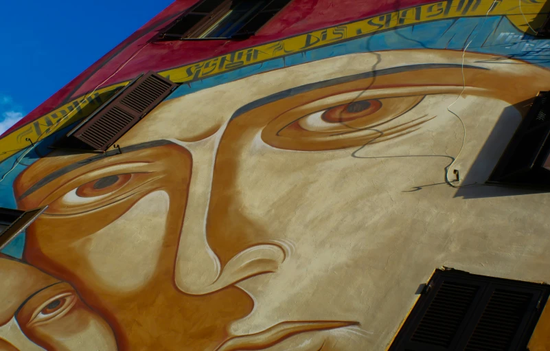 a painting depicting the faces of two people painted on a building