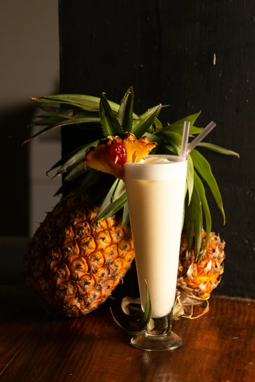 a large glass of milk and a pineapple