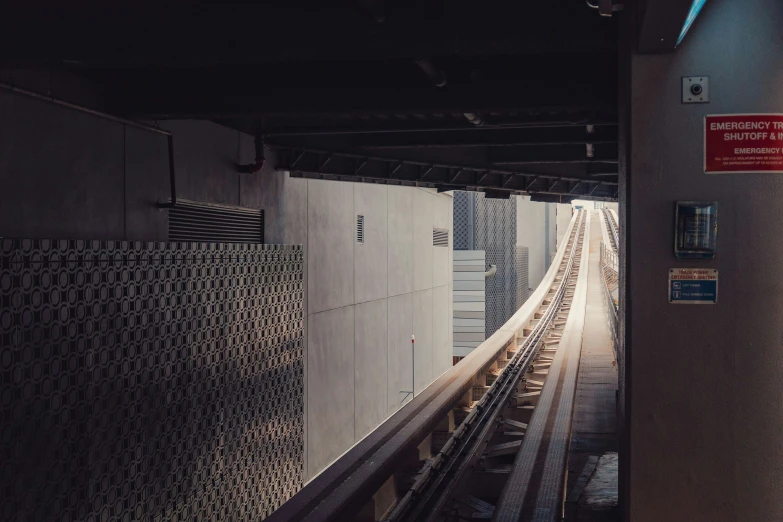 an empty subway station with railings and a tunnel