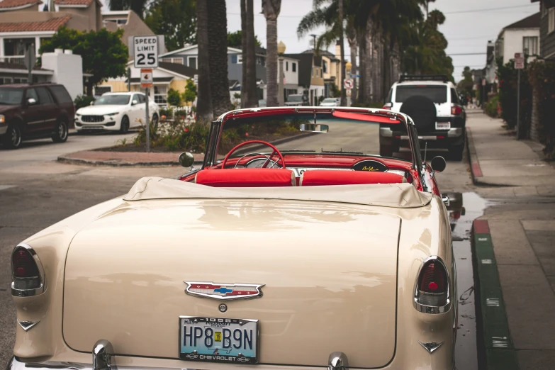 a classic car is parked on the side of the road