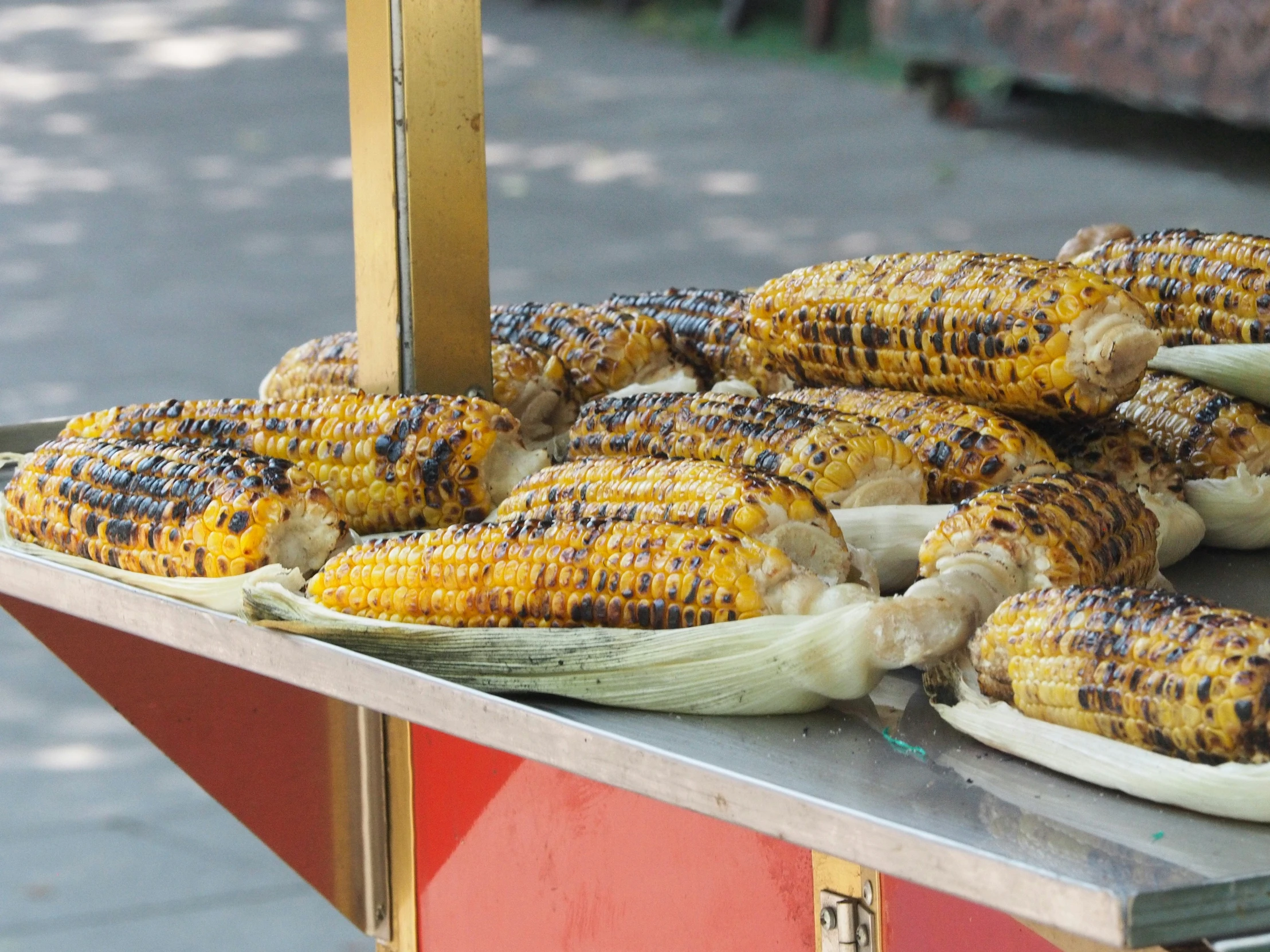 corn is being grilled and arranged on a grill