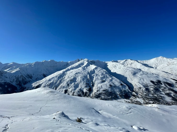 the man is riding his skis down a mountain