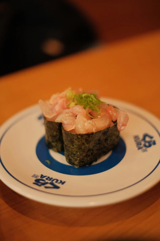 a small plate filled with a piece of sushi