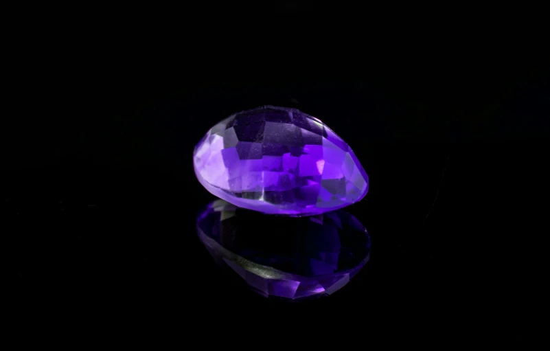 a purple glass object sitting on top of a table