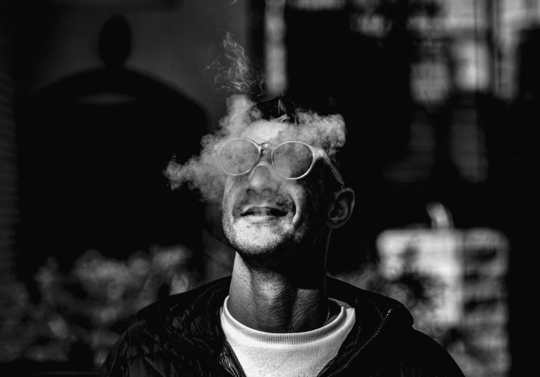black and white po of man smoking an electronic cigarette