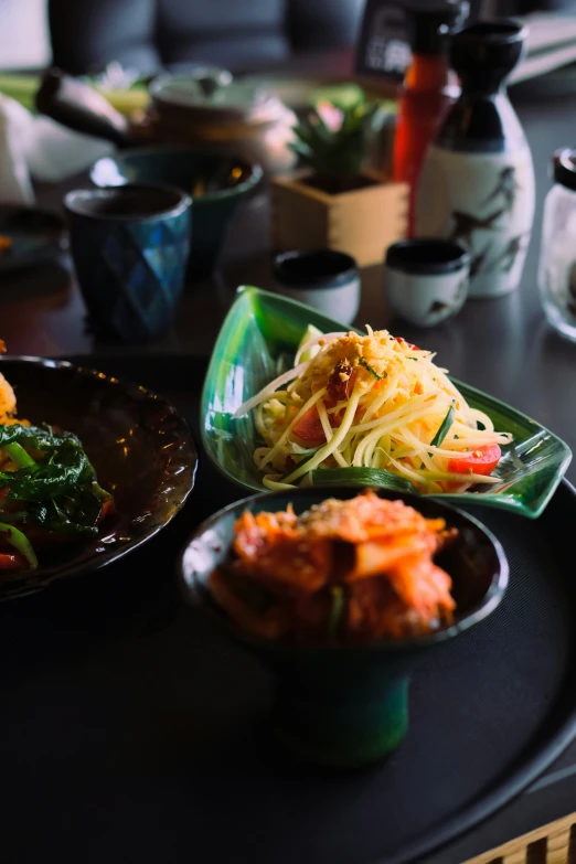 an array of food is sitting on a round table