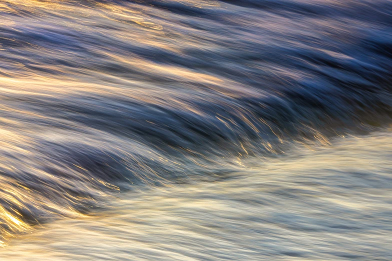 a wavy ocean with sun reflecting off it