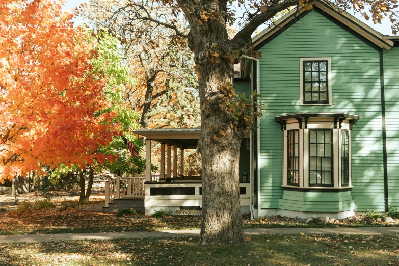 a house in the fall with its green exterior