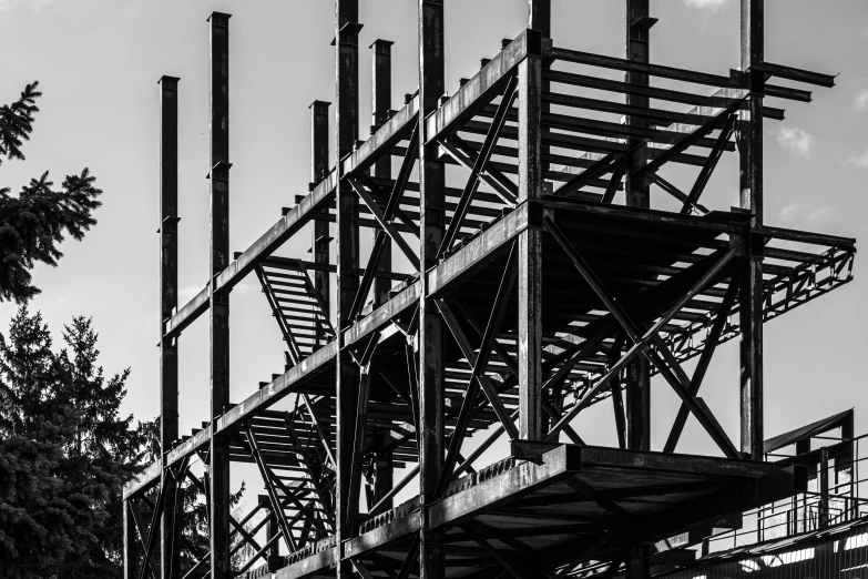 a building with metal frame supports and trees