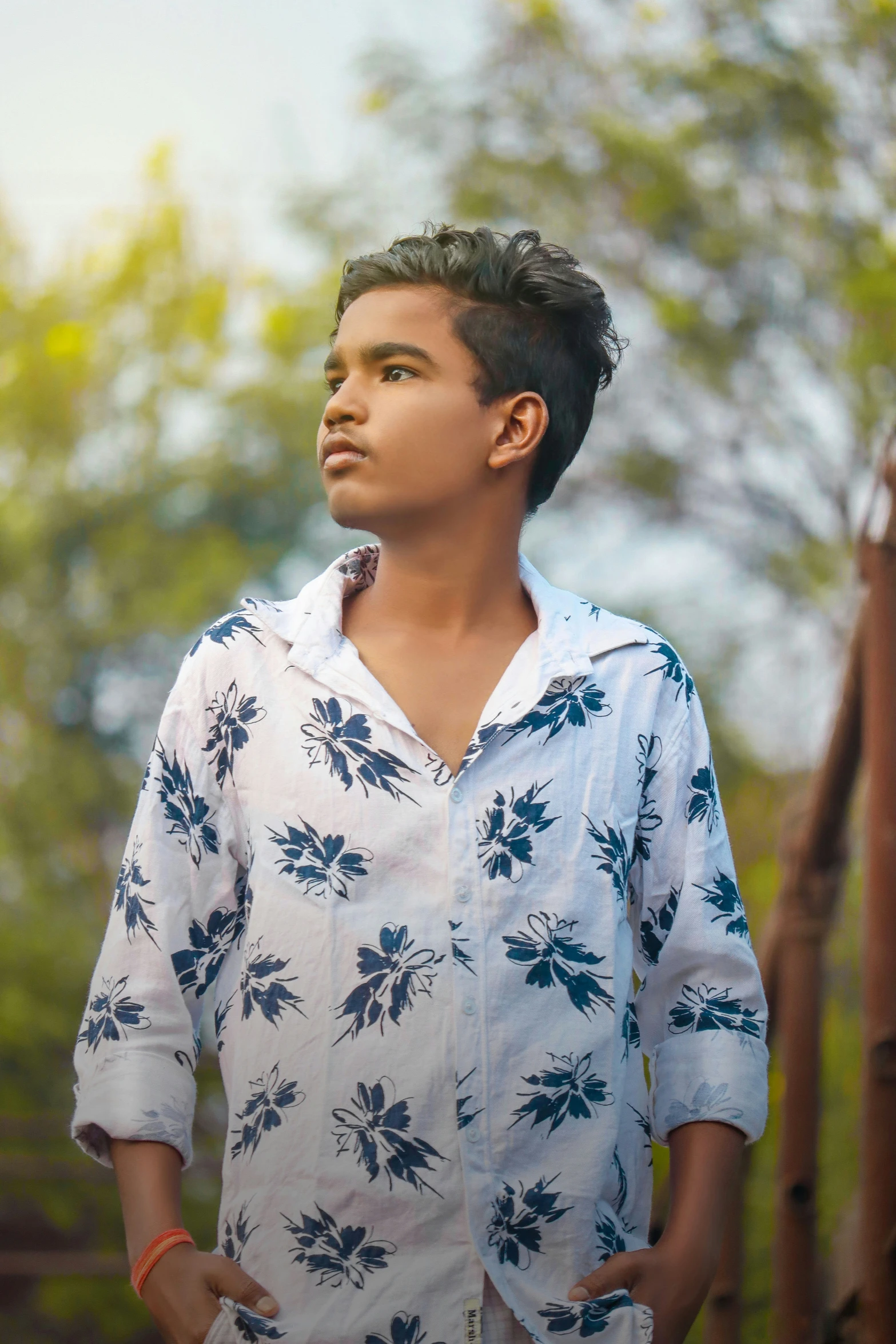 a person in a floral shirt looks away from the camera