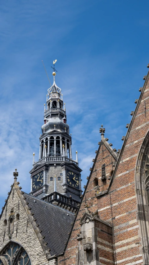 a very tall tower with some spires next to buildings