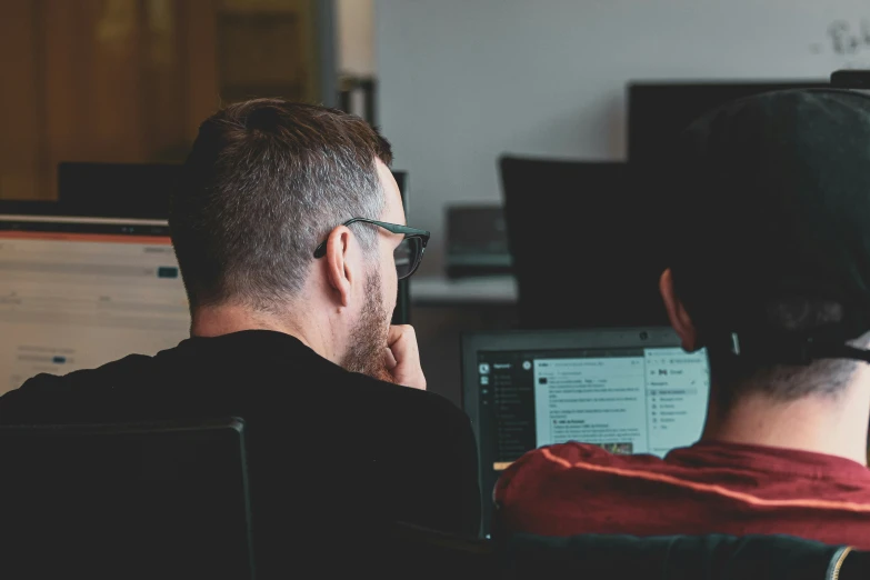 a man sitting at a desk working on his computer