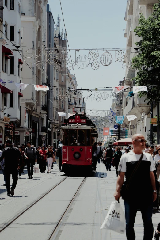 a street with people walking on it near many trams