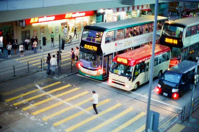 two double decker buses and a bus stop