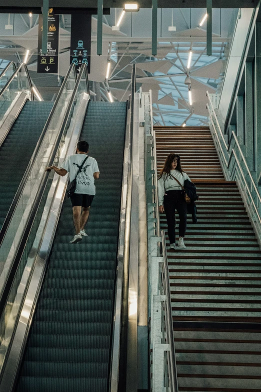 people riding an escalator at an airport