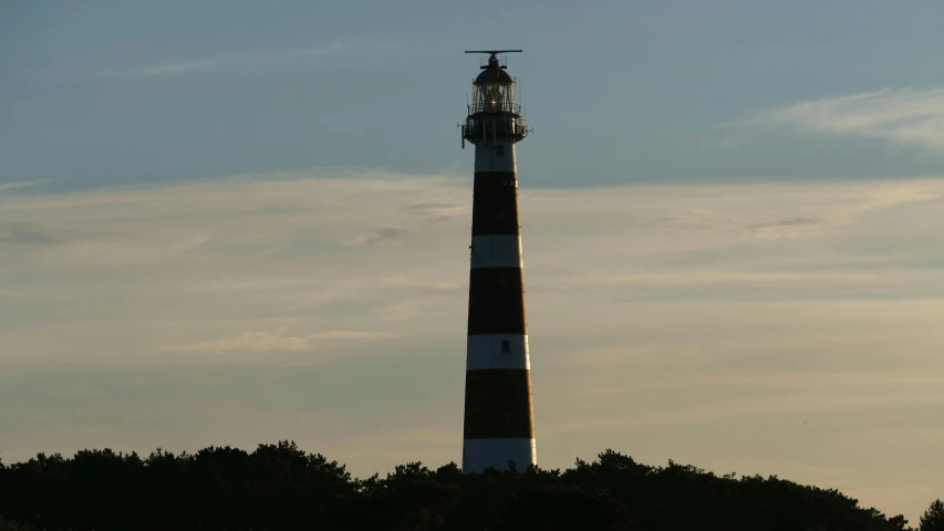 a small lighthouse on top of some trees