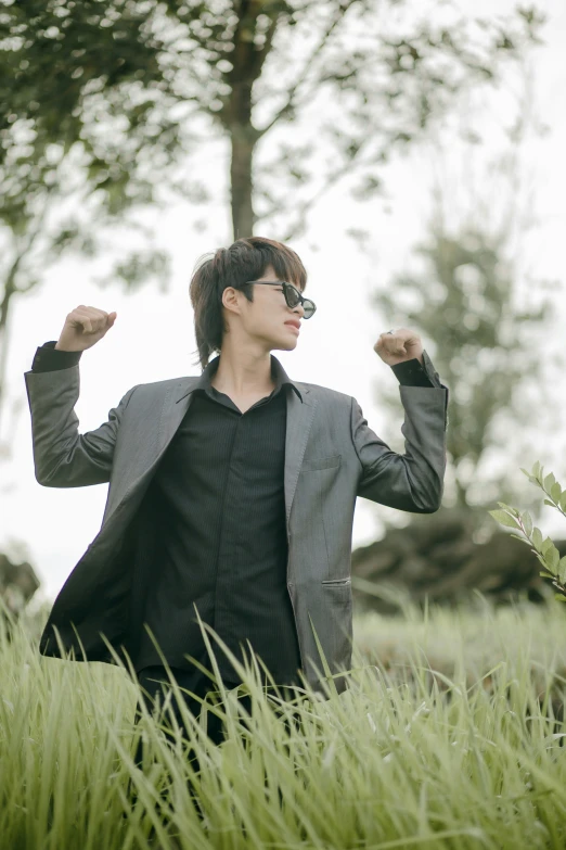 man with his fists raised in the field