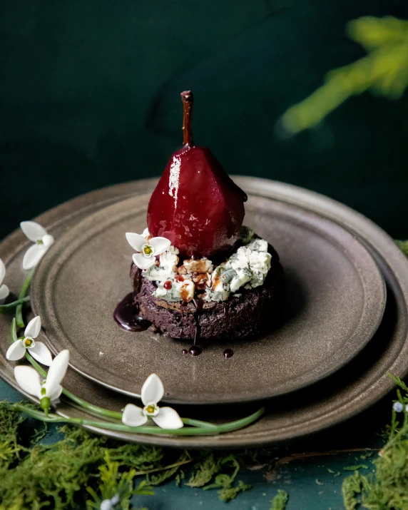 two desserts sit on two plates with flowers in the background