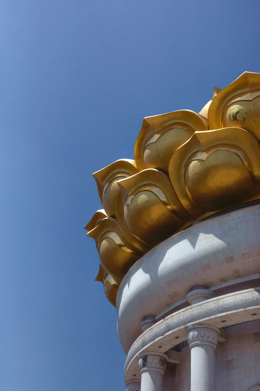 a large golden item with an unusual roof on it