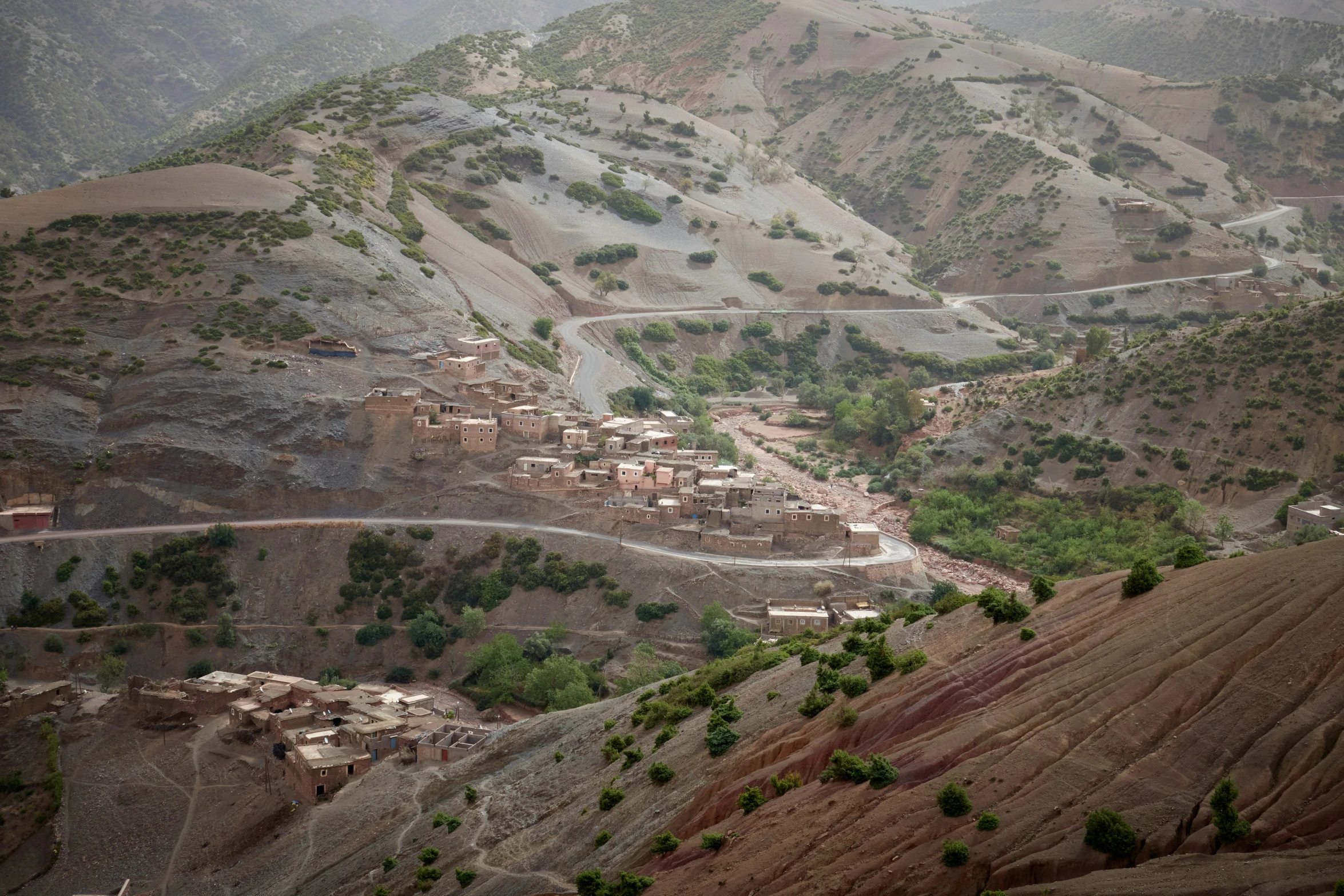 this landscape has multiple layers of rock, trees and bushes