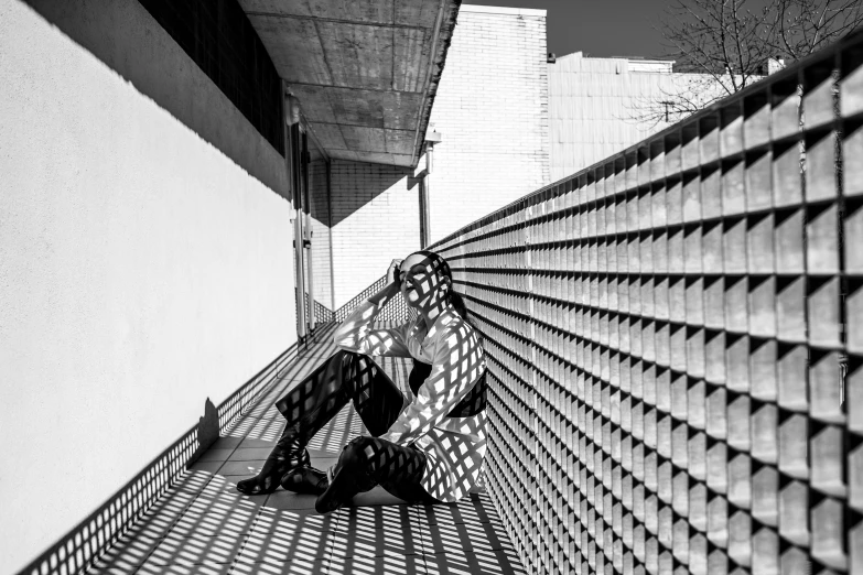 a woman walking down a street near tall buildings