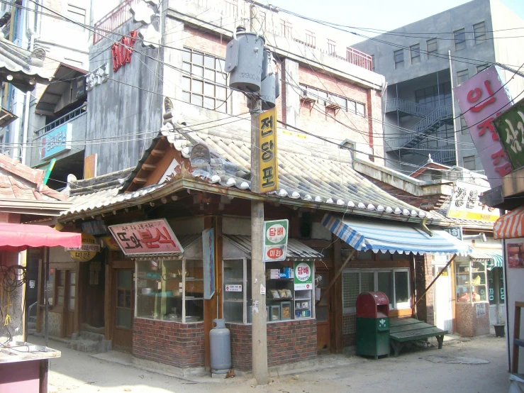 an outdoor shopping center, with signs and banners on its facade