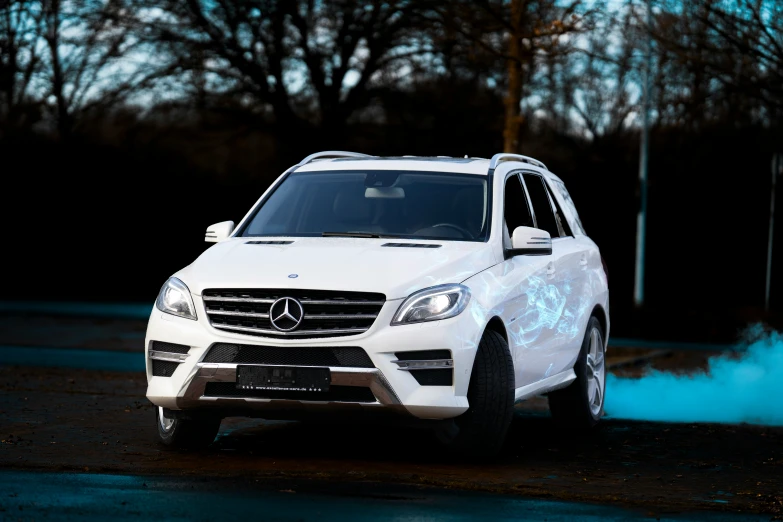 a mercedes gle is blowing smoke off the road